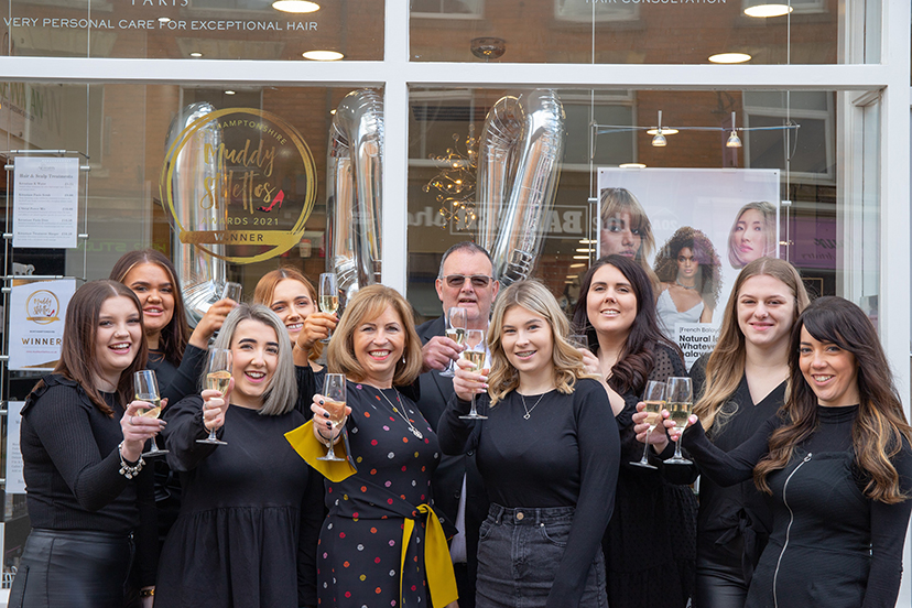 A cut above: Clients join staff in celebrating salon’s centenary